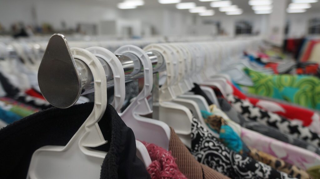 Clothes hanging on a rack in a thrift store