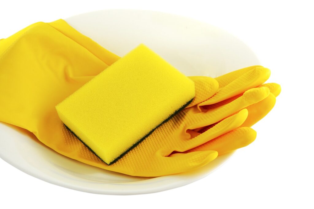 Yellow sponge on top of yellow rubber gloves
